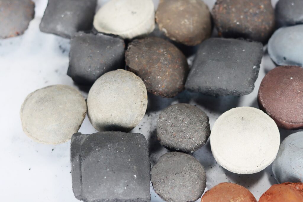 briquettes in diffrent shapes made from different raw material including steel dust, mill scale, coal, coke, metal powder, and mineral powder, scrap iron